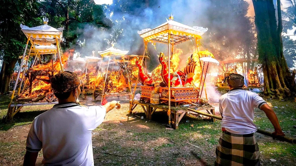 Balinese Ngaben cremation ceremony with traditional structures and fire ritual